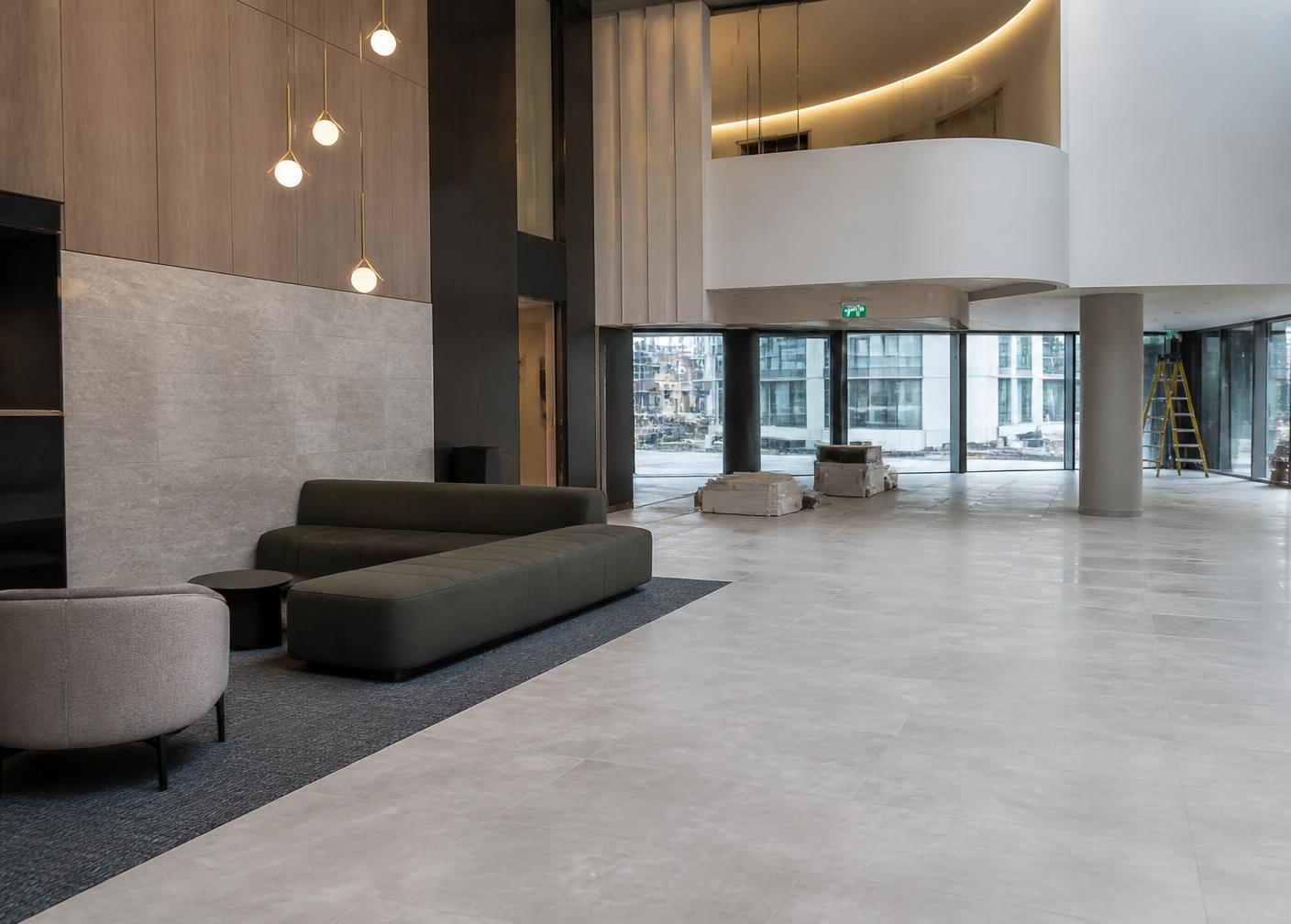 Large-format porcelain floor tiling in a new apartment building lobby