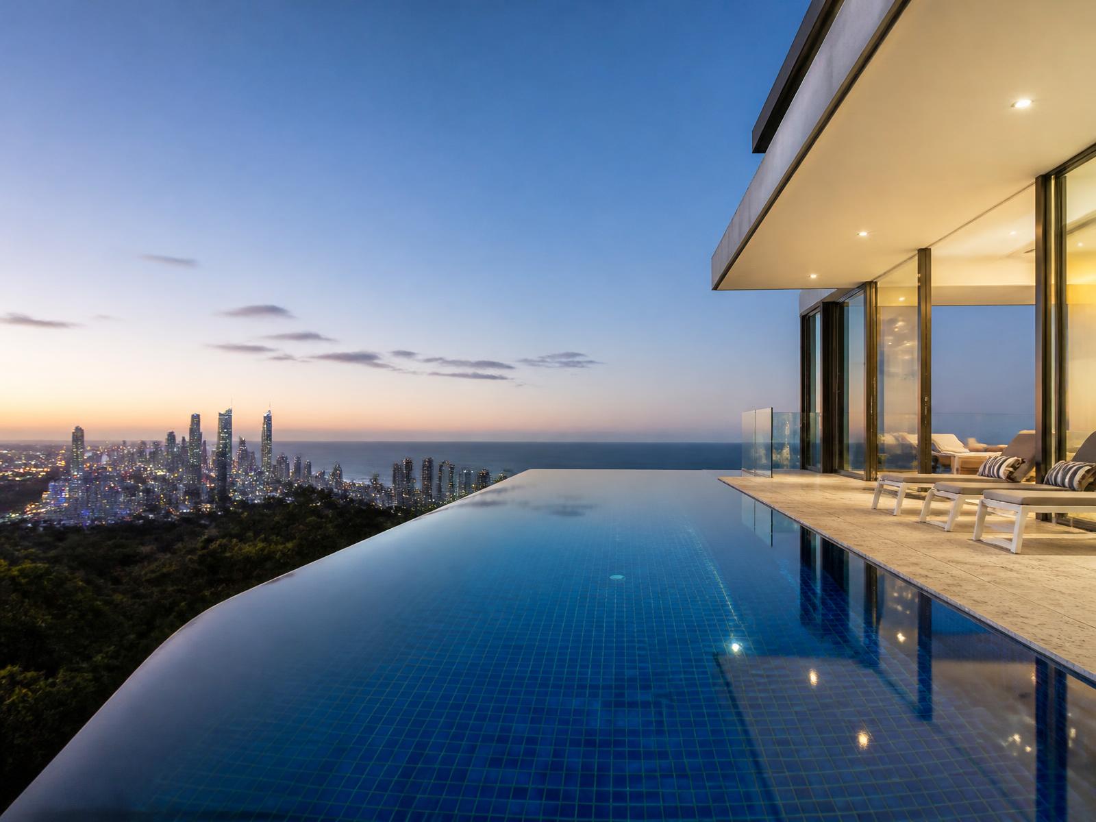 Infinity edge tiled pool overlooking the Gold Coast skyline at dusk